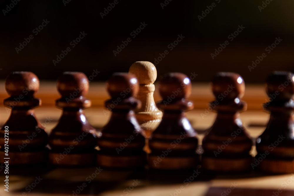 One white chess pawn among the black pawns. The concept of black lives matter