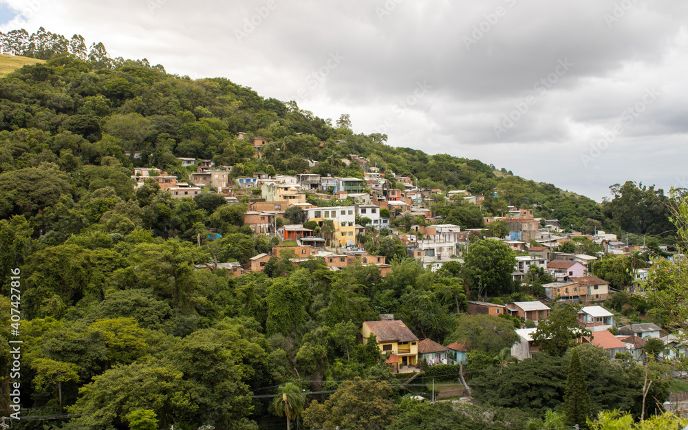 PORTO ALEGRE, RIO GRANDE DO SUL, BRAZIL - JANUARY 21, 2021: View of a community located next to Hospital Divina Providência on a hill amidst trees.