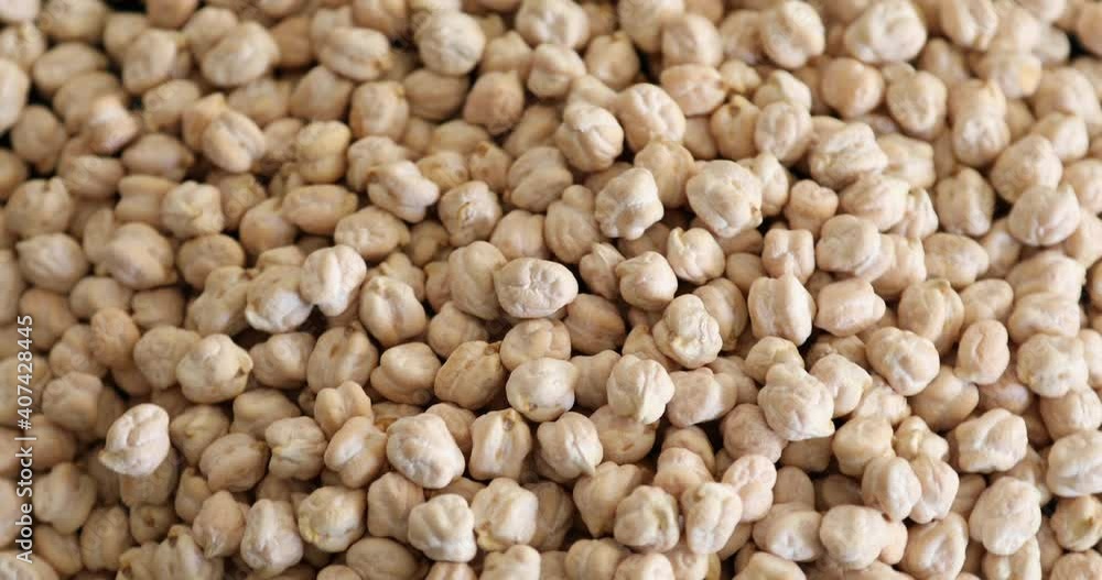 Close up view of uncooked organic chickpea rotating Close up view of uncooked organic chickpea rotating