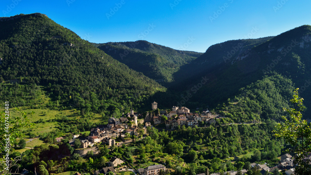 Magnificent mountain landscape in the causses with a view of a village in the Massif Central.