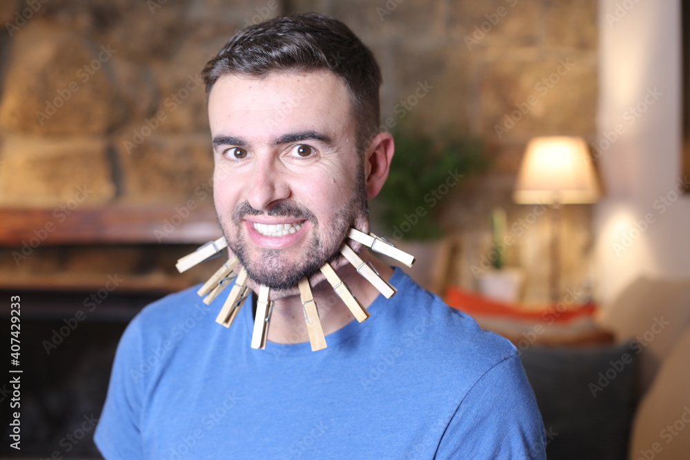 Man stretching chin skin with clothespins Stock Photo | Adobe Stock