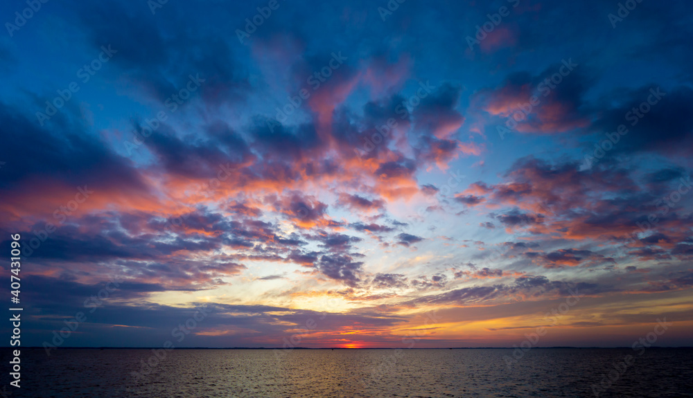 view of the north carolina outer banks sound at sunset. water and sky are vivid and the water calm. taken in late summer.