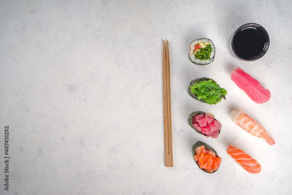 Japanese seafood sushi set. Various sushi and sushi rolls on white background. Top view with copy space for text Japanese seafood sushi set. Various sushi and sushi rolls on white background. Top view with copy space for text