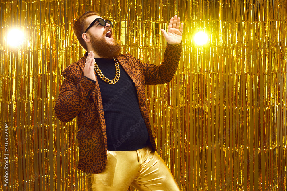 Excited rich red-haired young man in neck chain and cool glasses having ...