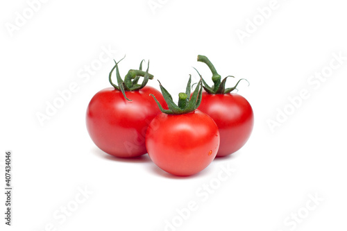 Three red tomatoes on a white background