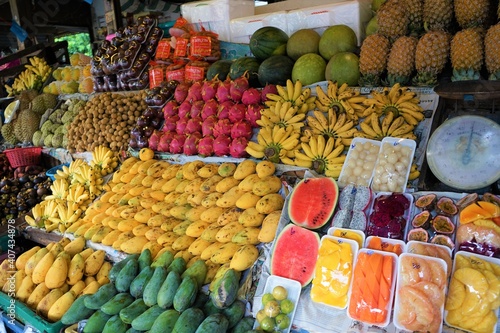 Fresh Fruits, Mango, Banana, Watermelon, Dragon Fruits and more on the counter of Stall in market, Pataya, Thailand - 果物屋 フルーツ