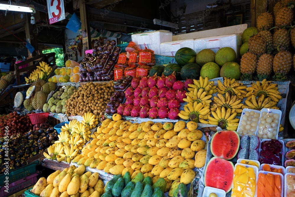 Fresh Fruits, Mango, Banana, Watermelon, Dragon Fruits and more on the counter of Stall in the market, Pataya, Thailand