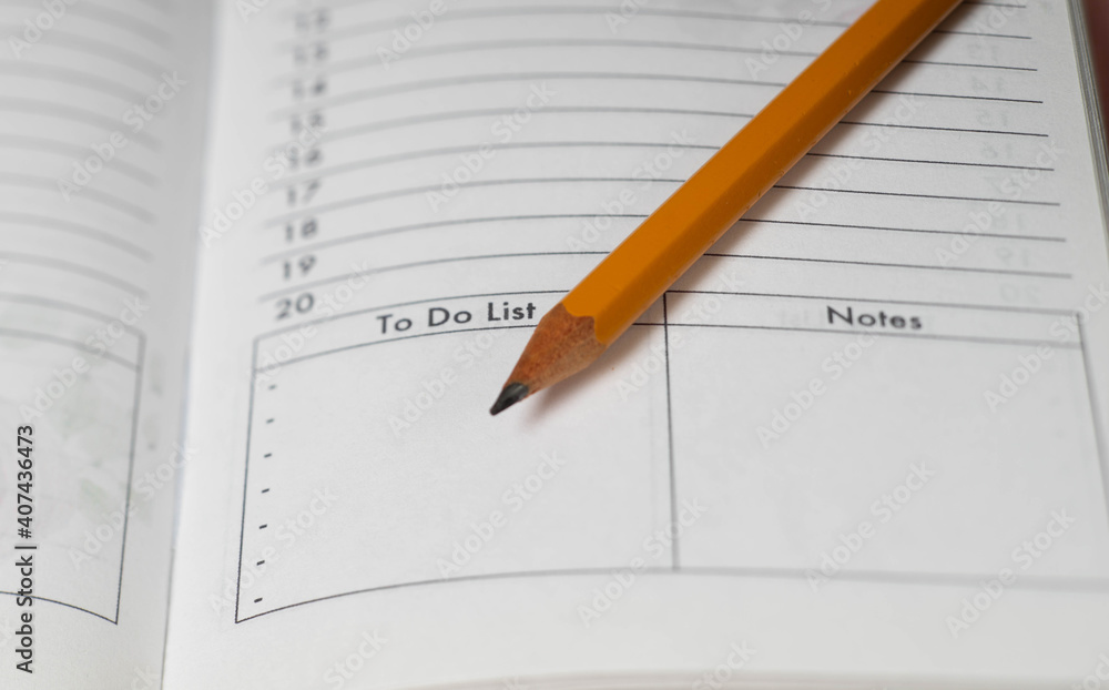 Pencil on opened diary notebook. Empty To do list and Notes. Close-up. Pencil on opened diary notebook. Empty To do list and Notes. Close-up.