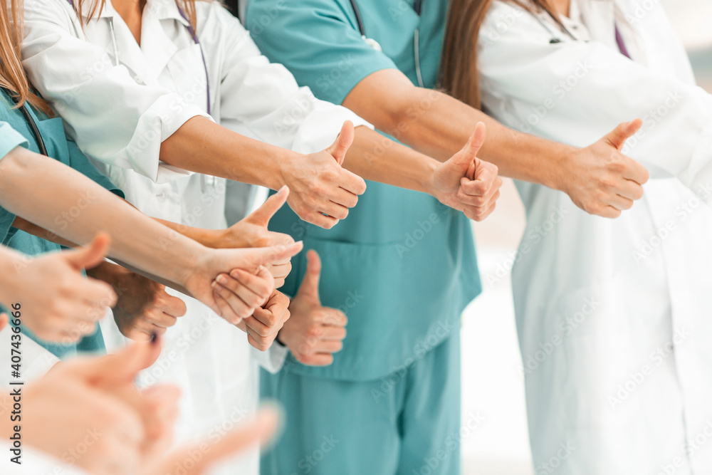 big team of medical professionals showing thumbs up. big team of medical professionals showing thumbs up.