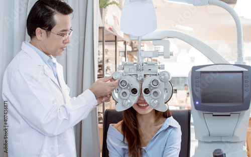 Ophthalmologist doing eyesight test to a woman