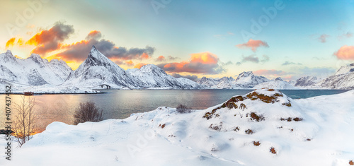 Fabulous morning view of Torsfjorden fjord with Fredvang cantilever bridge and Volandstinden peak at sunrise photo