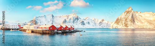 Traditional Norwegian red wooden houses (rorbuer) on the shore of  Reinefjorden near Hamnoy village. © pilat666