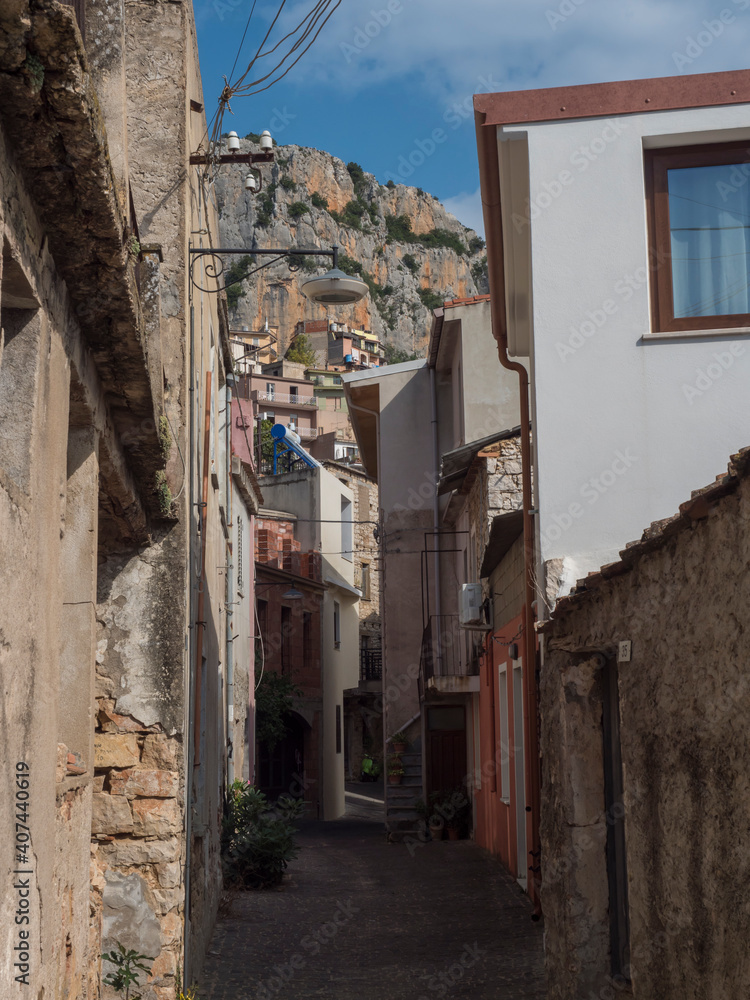Fototapeta premium View of narrow streets of old romantic mountain village Baunei with stone houses. Ogliastra, Sardinia, Italy, Sunny summer afternoon