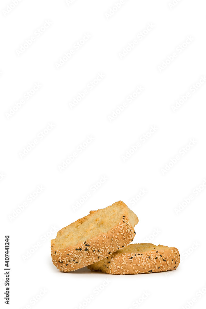 Pile of two wheat rusks with sesame seeds isolated on white background Pile of two wheat rusks with sesame seeds isolated on white background