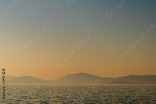 Hazy sunset seascape with sea horizon and clear sky, with mountain islands in the far end, Princes Islands, Sea of Marmara near Istanbul, natural photo background