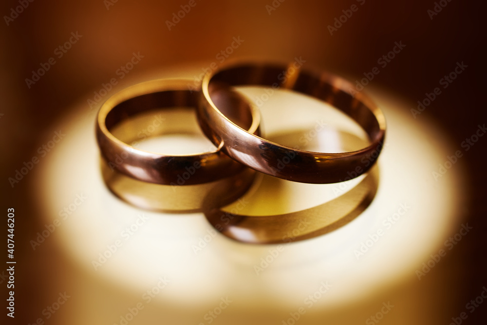 gold wedding rings on a glass surface. preparing for the wedding. close-up, macro gold wedding rings on a glass surface. preparing for the wedding. close-up, macro