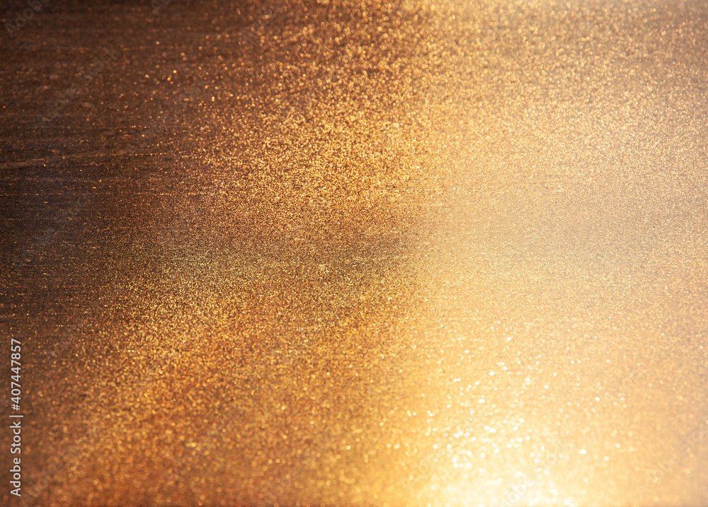 Abstract golden background with many small sparkles. Gradient from dark to light Abstract golden background with many small sparkles. Gradient from dark to light