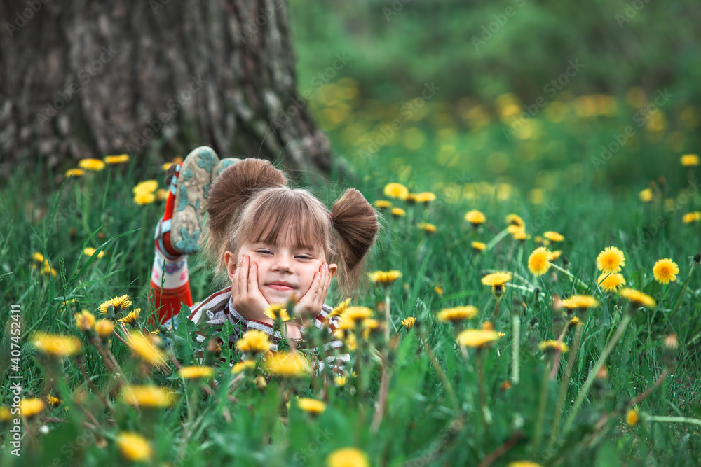 Little girl lying in the green grass in park. Little girl lying in the green grass in park.