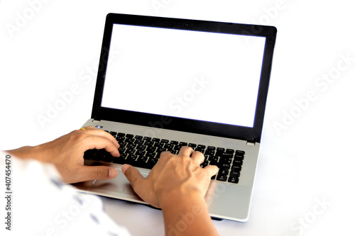 Business person or office worker using laptop computer while sitting at desk