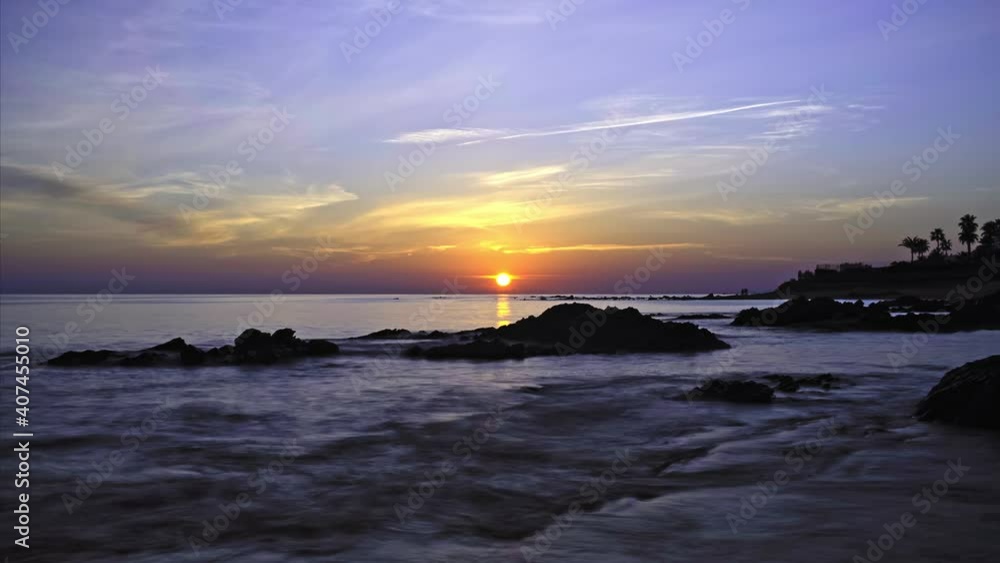 Sunset time lapse at a rocky beach