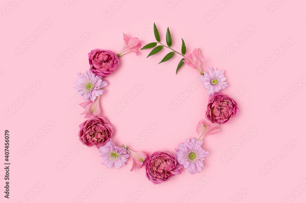 Round frame made of rose, aster and alstroemeria on a pink pastel background. Flower wreath. Festive springtime concept. Round frame made of rose, aster and alstroemeria on a pink pastel background. Flower wreath. Festive springtime concept.