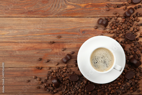 cup of coffee, coffee beans and chocolate on the table close up