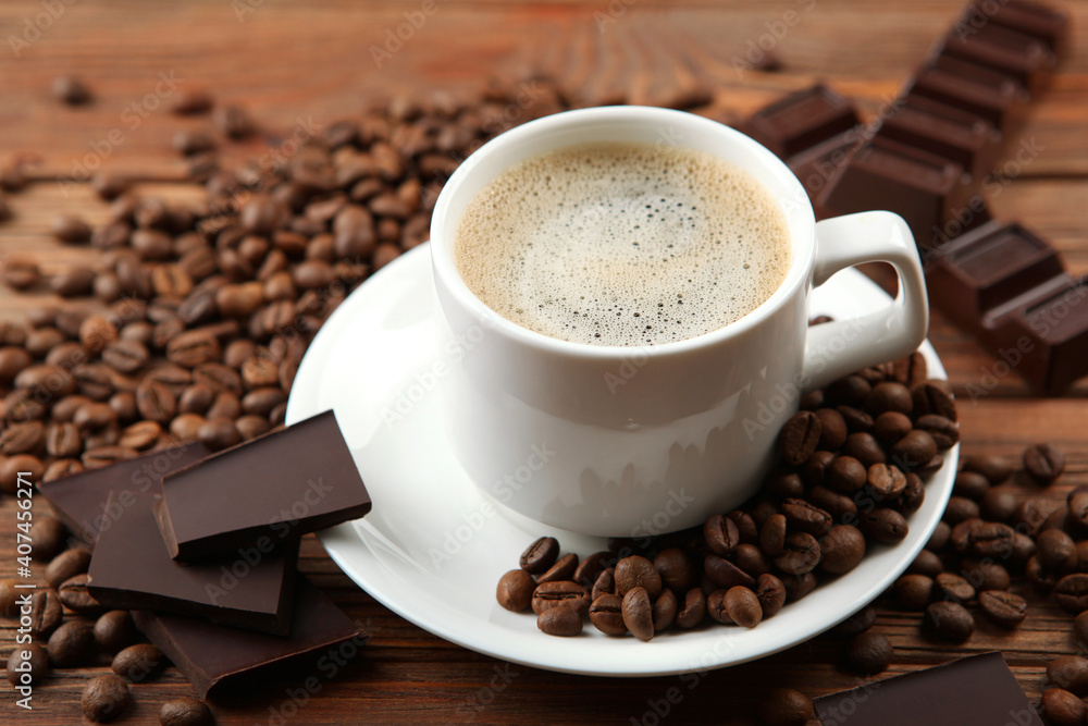 cup of coffee, coffee beans and chocolate on the table close up cup of coffee, coffee beans and chocolate on the table close up