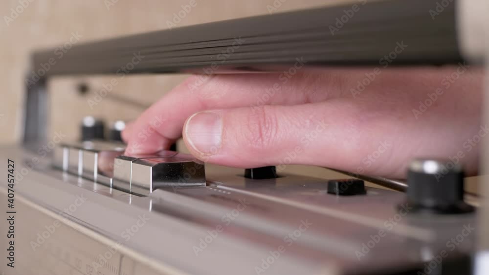 Female Hand Presses Buttons on Retro Tape Recorder with Antenna. 4K Female Hand Presses Buttons on Retro Tape Recorder with Antenna. 4K