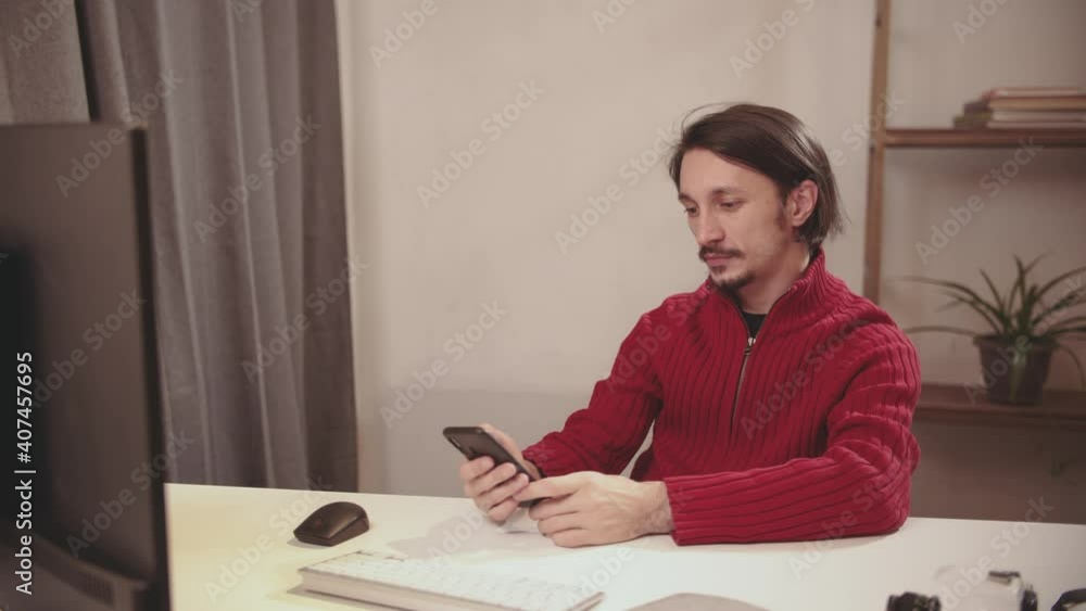 the guy talks through a webcam and on the phone the guy talks through a webcam and on the phone