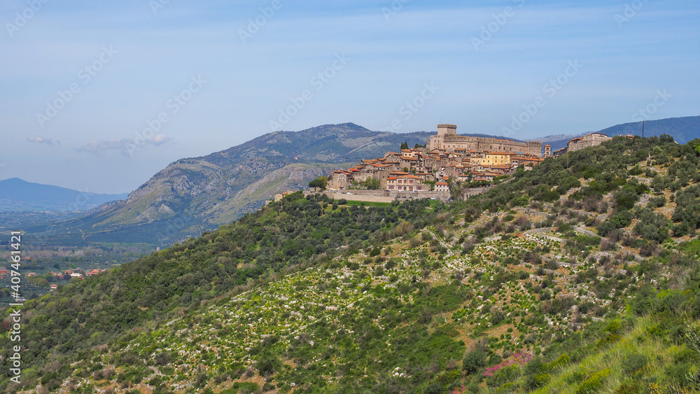 Hill town Sermoneta, famous small village, with medieval Caetani castle on the top, and old stony houses around. Ancient cityscape in Italy, Lazio region, Latina province. Beautiful Italian landscape.
