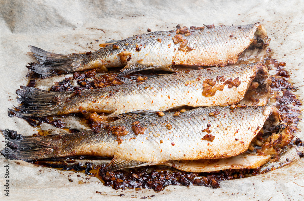Oven baked mackerel with lemon and ginger on baking paper Oven baked mackerel with lemon and ginger on baking paper