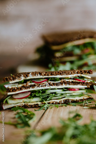 Food still life, fresh whole grain bread with cheese, radish, cucumber, arugula, healthy food, superfood