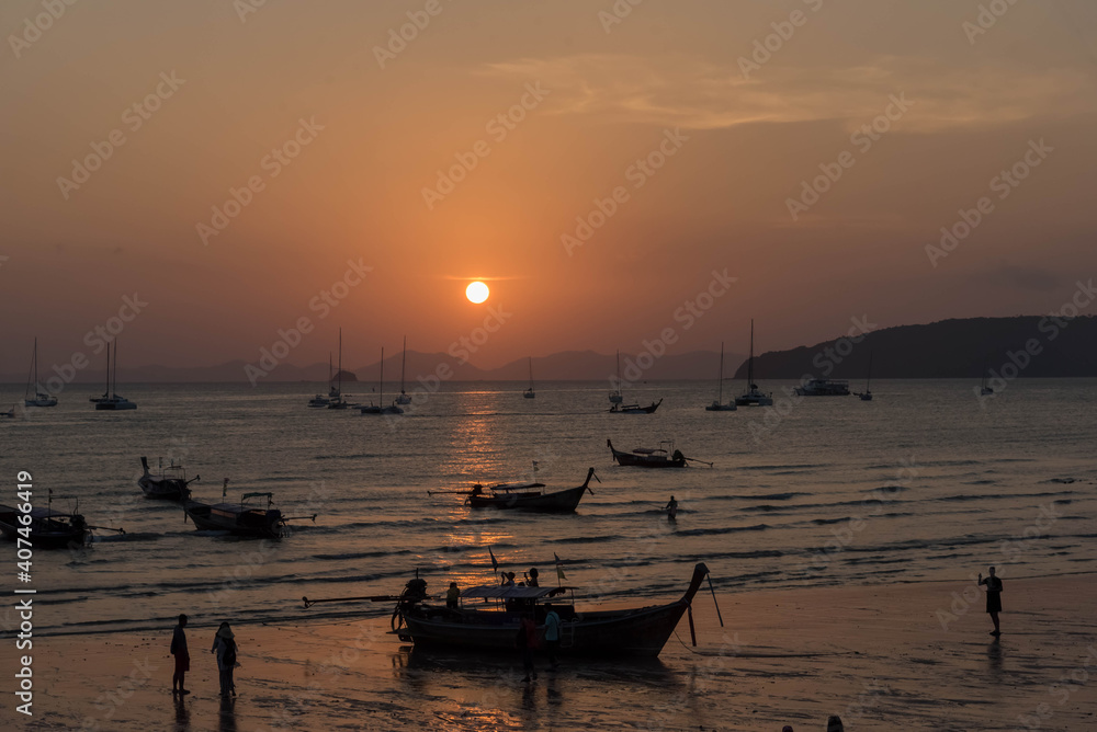 Nature in twilight period which including of sunrise over the sea and the nice beach. Summer beach with blue water and purple sky at the sunset.