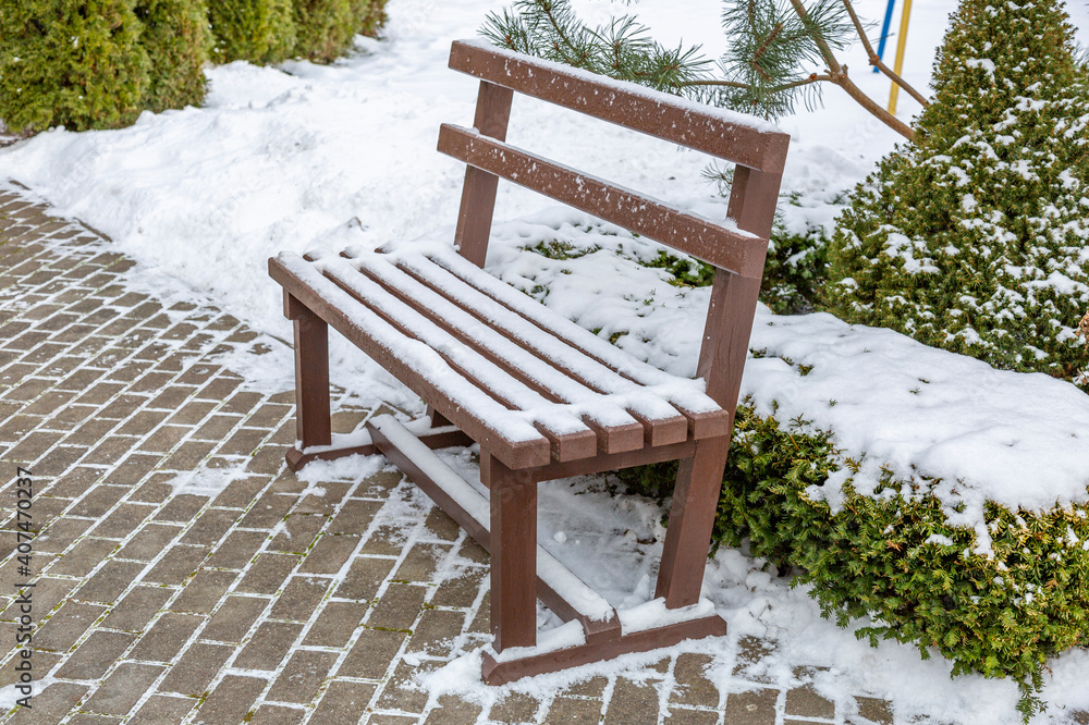 A recreation bench for tourists in the resort town on a winter day A recreation bench for tourists in the resort town on a winter day