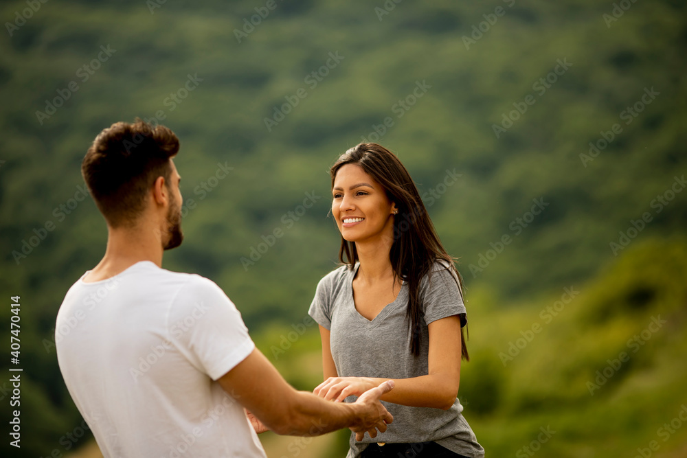 Happy young couple in love at the grass field Happy young couple in love at the grass field