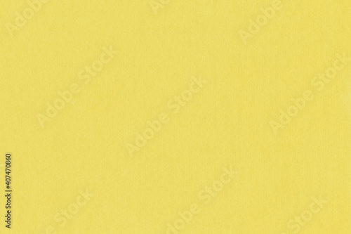 Clean yellow retro paper background. Vintage cardboard texture. Grunge paper for drawing. Simple blank fabric pattern.