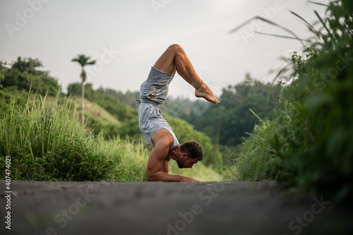 Man practice Yoga outdoor. Practice and meditation in jungle.