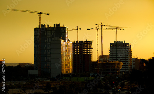 Buildings under construction in the city at sunset