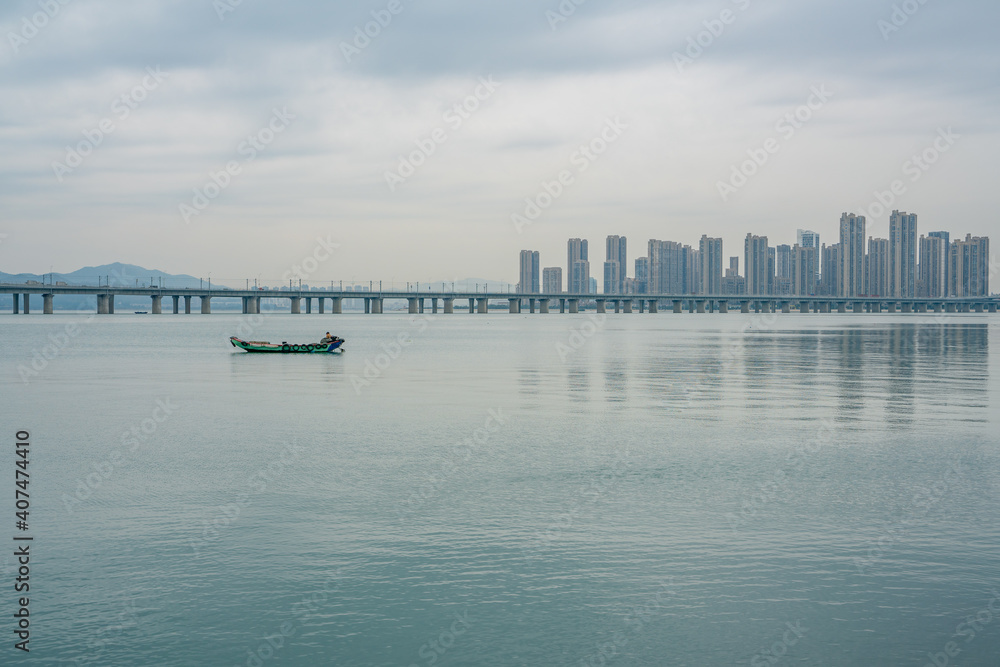 The fishing boats in the bay by Xiamen bridge, on a cloudy day.