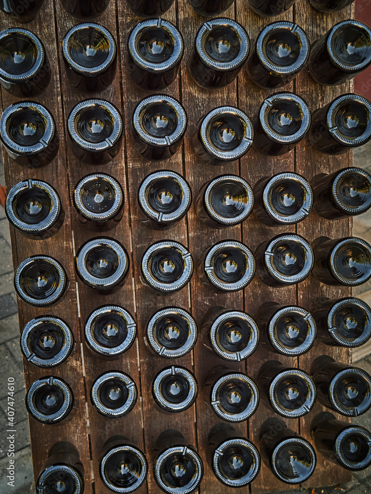 Wine bottles in a wooden stand outside. Wine restaurant Wine bottles in a wooden stand outside. Wine restaurant