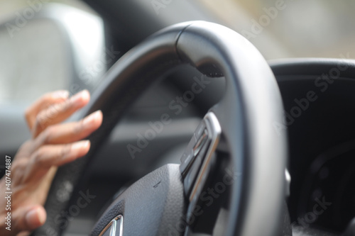 Someone driving , close up hands on steering wheel