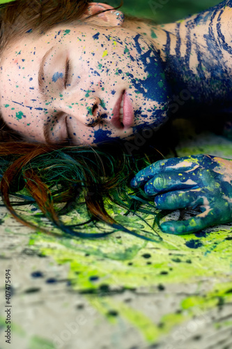 unusual remarkable impressive portrait of a sexy young brunette redhead woman, dots of blue and green color, creative expressive abstract body painting art, make up, copy space.