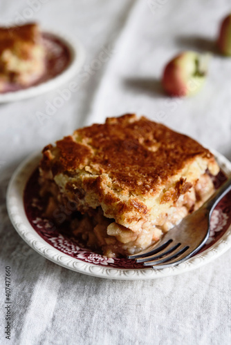 Apple and Cheese Cobbler Crisp. Cobbler or Crumble dessert with apples on plates on beige linen table. Selective focus