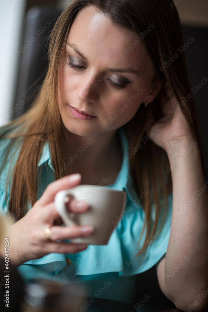 custom made wallpaper toronto digitalYoung beautiful girl with brown hair drinks coffee in a cafe.