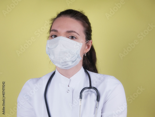 Medical staff preventive gear against coronavirus. Portrait of female doctor with stethoscope in mask. 