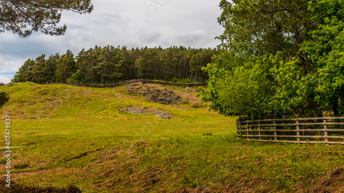 A view from Cropston reservoir towards a Charmian Rock outcrop in Bradgate Park in Leicestershire in summertime photo