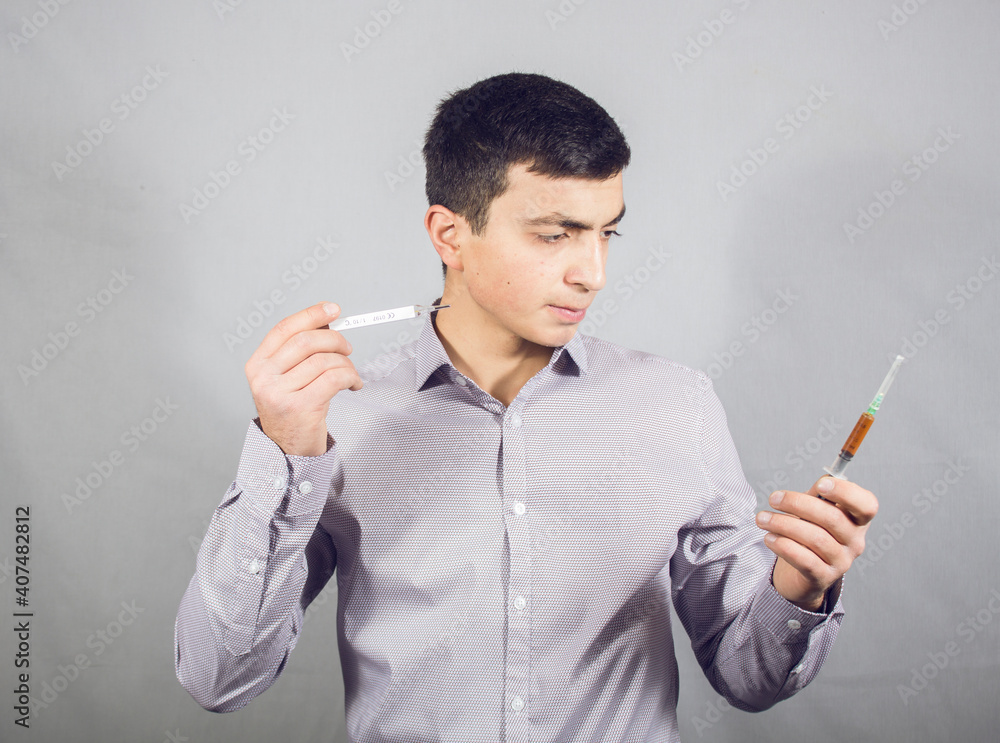 holding a thermometer and syringe holding a thermometer and syringe