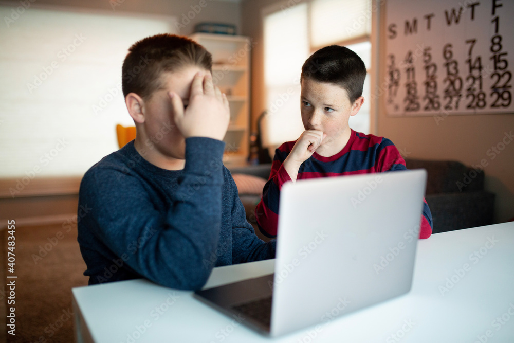 boy covering his eyes while looking at a laptop
boy covering his eyes while looking at a laptop