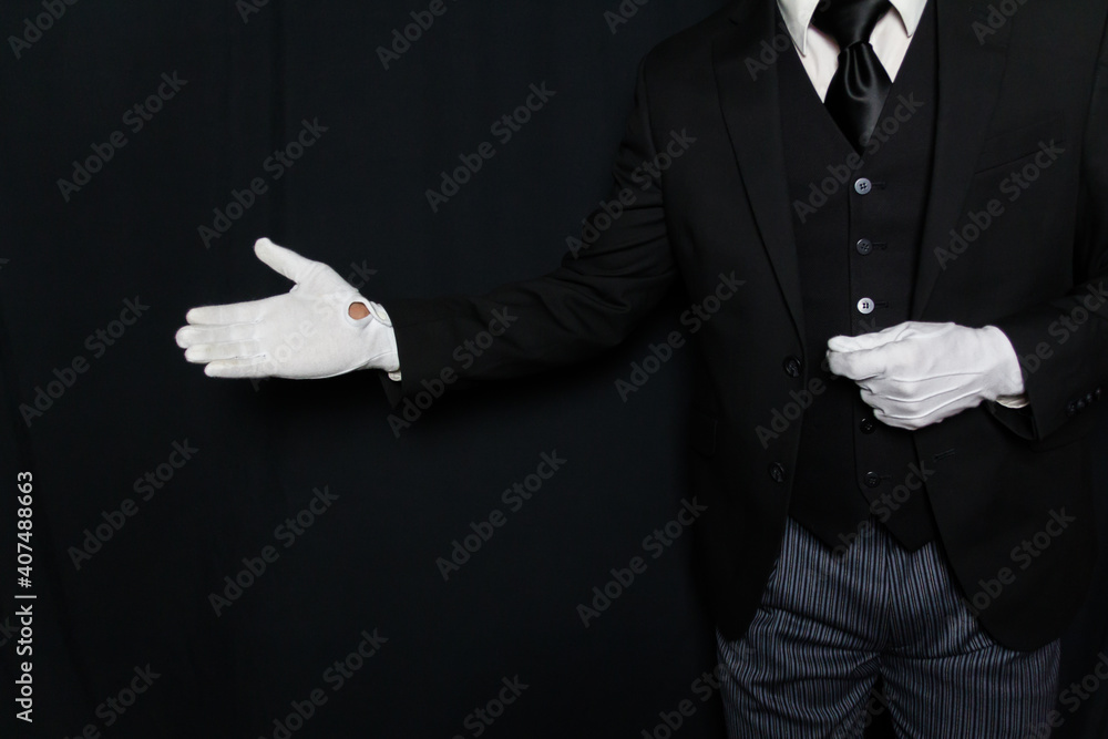 Poster Print Black and White Portrait of Butler or Servant in Dark Suit and White Gloves with a Welcoming Gesture 40x26.7 cm