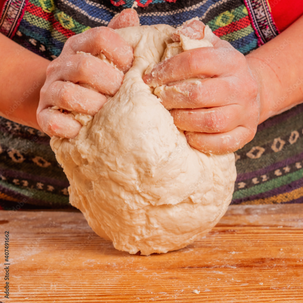 Young woman kneading dough. Food, сooking process, sweets concept.
